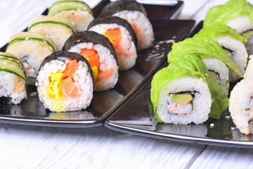 Sushi rolls on wooden background
