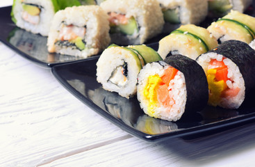 Sushi rolls on wooden background