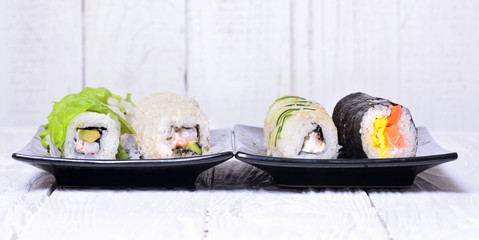 Sushi rolls on wooden background