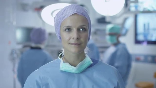 Nurse using Imaginary Futuristic Analytical Interface in Operating Room. Great for Mockup usage. Shot on RED Cinema Camera.