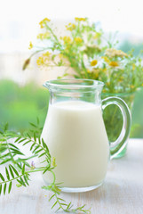 Jug of milk and bouquet wild flowers