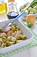 Roasted Brussels Sprouts with Red Onions and Pears in a baking dish white