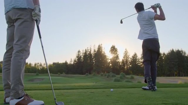 Golfer takes a few practice swings then hits his shot 