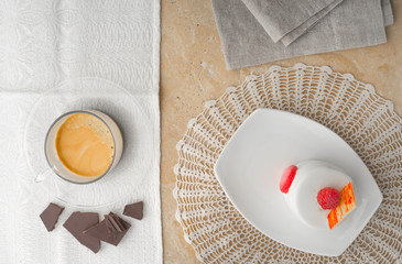 White cake with raspberry, coffee and chocolate  top view