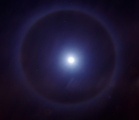 Fototapeta na wymiar Halo around the moon Or a light ring around the moon. Photo taken on 18.06.2016 in Israel . This phenomenon exists because ice crystals suspended in the atmosphere 