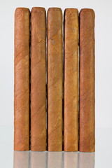 Different cigars on a  glass desk