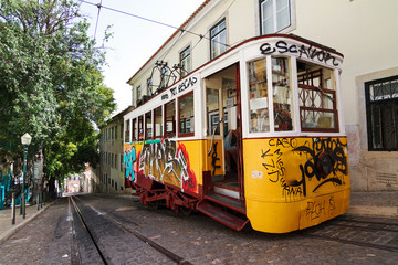 Steep street Calcada da Gloria with traditional trams in Lisbon, Portugal