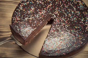 Homemade chocolate cake on wooden background. Selective focus. T