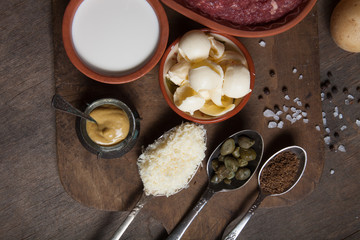 Set of ingredients for cooking on old wooden background