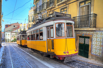 Fototapeta na wymiar Beautiful image of the traditional yellow trams in Lisbon, Portugal. HDR