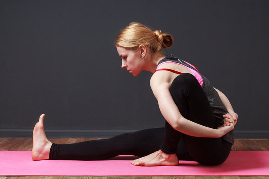 Yoga. Pilates. Stretching. Young blonde woman doing yoga exercise
