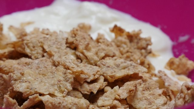 Morning cereals and yogurt breakfast natural mix 4K 3840X2160 30fps UHD footage - Fibers rich food of yogourt and corn and rice cereal 4K 2160p UltraHD video 
