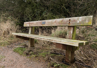 old weathered distressed wooden bench with earthy colours