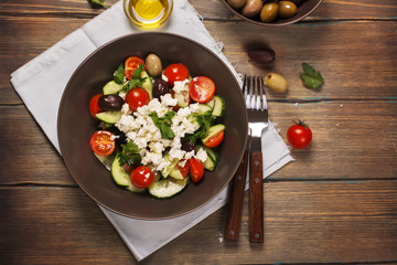 Traditional greek salad with fresh vegetables, feta cheese and olives. Top view. Rustic style. Selective focus