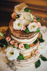 Obraz na płótnie Canvas Wedding cake with roses whipped cream