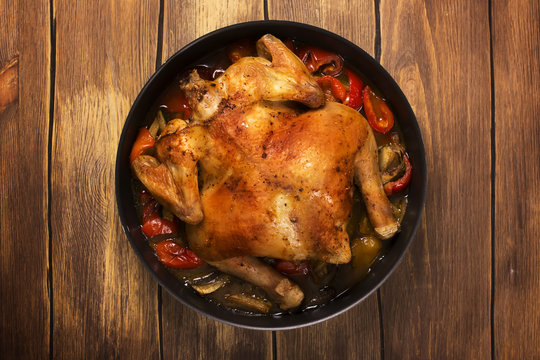 Whole baked chicken with spicy vegetables. Rustic style. Selective focus