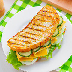 Plate with delicious sandwich on table, top view