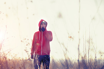 Portrait of men runner in the field with headlamp/Men running in the field, trail running, jogging,with headlamp,morning