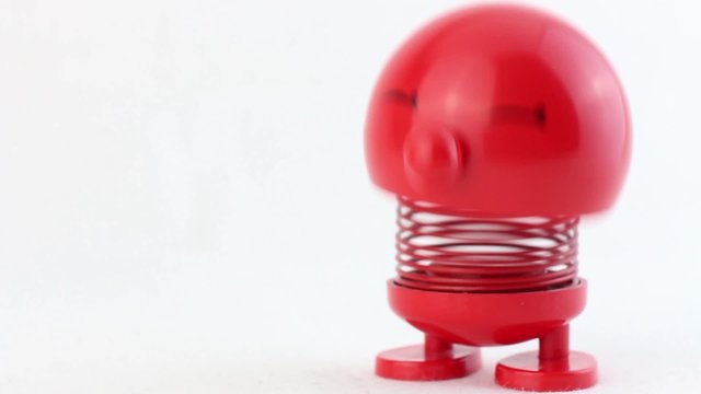 Red figure with metal spring laughing and jumping for creative use