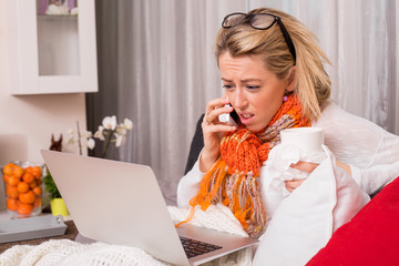 Sick woman working from home and talking on the phone 