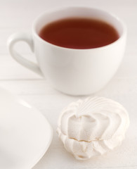 Fototapeta na wymiar soft marshmallows and a cup of tea on a white background natural