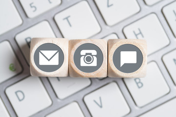several contact options as icon on little cubes on a keyboard