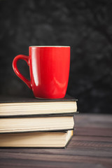 The red circle and black books on a dark background