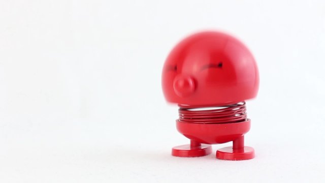 Red figure with metal spring laughing and jumping for creative use