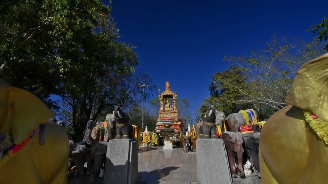 Dolly camera movement among elephant statues in a shrine in Phuket. Thailandia.
