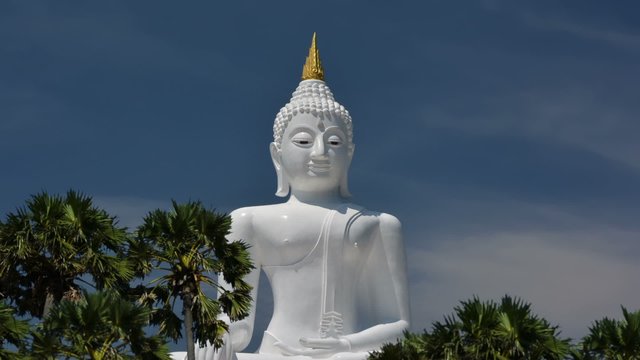 Big marble buddha statue with blue sky