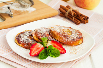 Apple rings dipped in batter with cinnamon and powdered sugar