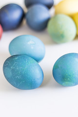 Easter, colorful painted eggs in in a cardboard box. Each color is from the different natural colorant.