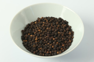 brown pepper in the white porcelain cup