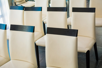 White leather chairs in a hall for conferences and lectures