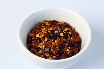 dried red pepper in the white cup
