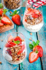 Homemade granola parfait with strawberry and mint.