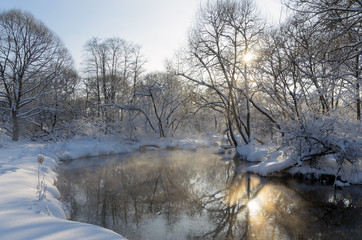 Sunny winter landscape with flowing river