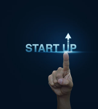Hand click on start up icon over blue background, Start up busin
