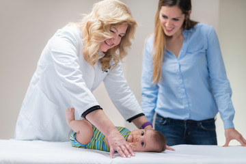 Pediatrician with baby boy and his mother