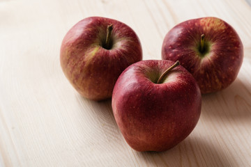 red apples on wooden table