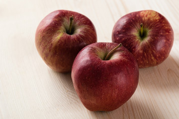 red apples on wooden table