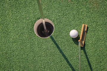 Putter with golf ball and hole