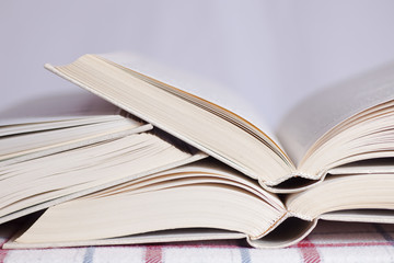 Pile of the opened books on a table