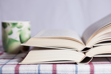 Pile of the opened books on a table