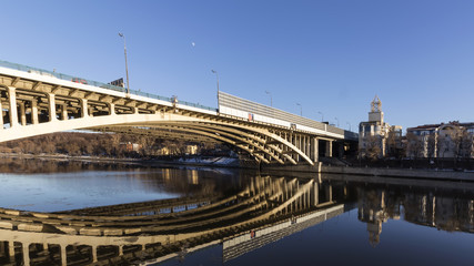 Naklejka premium Details of steel bridge and reflection in water of moscow river