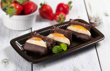 Candied orange dipped in chocolate and chocolate rolls 