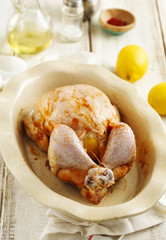 Raw whole chicken stuffed lemon and spices preparing for cooking