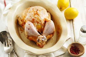 Raw whole chicken stuffed lemon and spices preparing for cooking