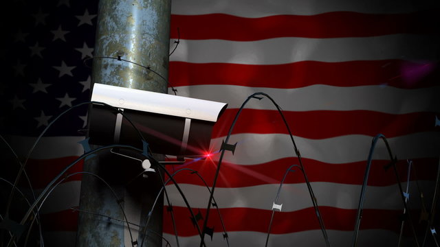 Security Camera on pole with razor wire making a seamless continuous pan with a United States of America flag background.