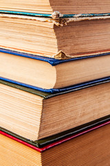 Old books on a wooden shelf.